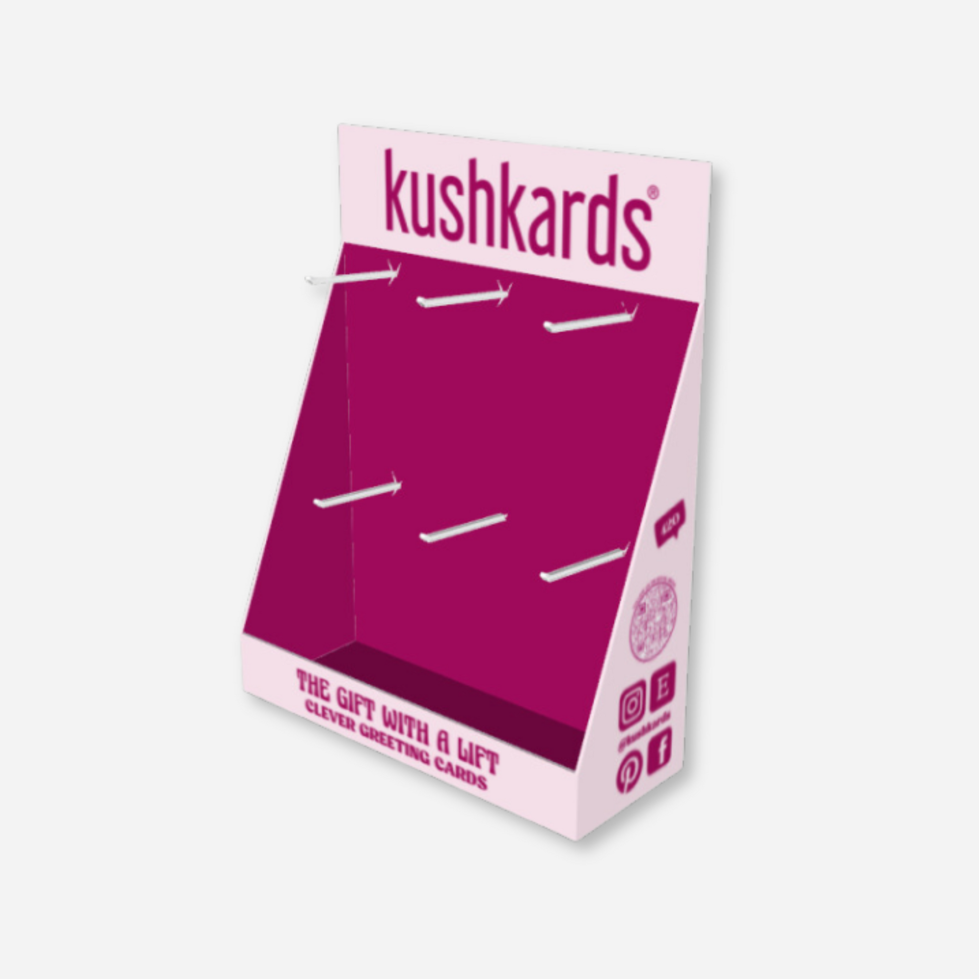 Empty two-tiered KushKards cardboard display stand with slot cutouts for product hanging and branding visible on the top header and bottom front panel.