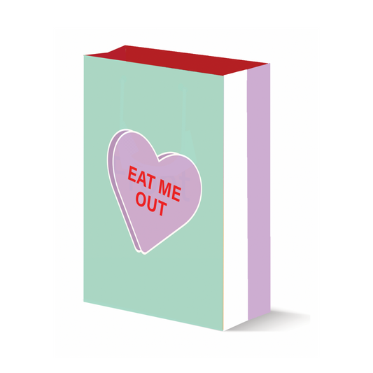 A tasteful sage-colored gift bag with a large purple Valentine's Day candy heart graphic prominently displaying the phrase 'Eat Me Out,' offering a playful and inviting design.