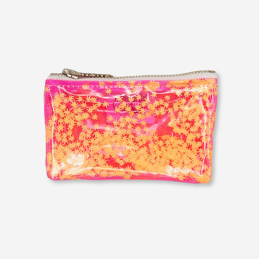 A bold and vibrant clear pink vinyl keychain clutch filled with floating orange cannabis leaf confetti. Designed by Kush Kards in collaboration with Julie Mollo, this stylish mini stash bag features a silver zipper and is perfect for carrying small essentials like rolling papers, lighters, and cash