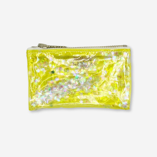 A vibrant clear yellow vinyl keychain clutch filled with holographic white cannabis leaf confetti. Designed by Kush Kards in collaboration with Julie Mollo, this stylish mini stash bag features a silver zipper and compact size, perfect for holding essentials like rolling papers, lighters, and cash