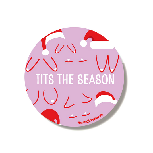 Lavender 'Tits The Season' round sticker featuring playful breast illustrations with Santa hats, perfect for holiday gifting and decorations.