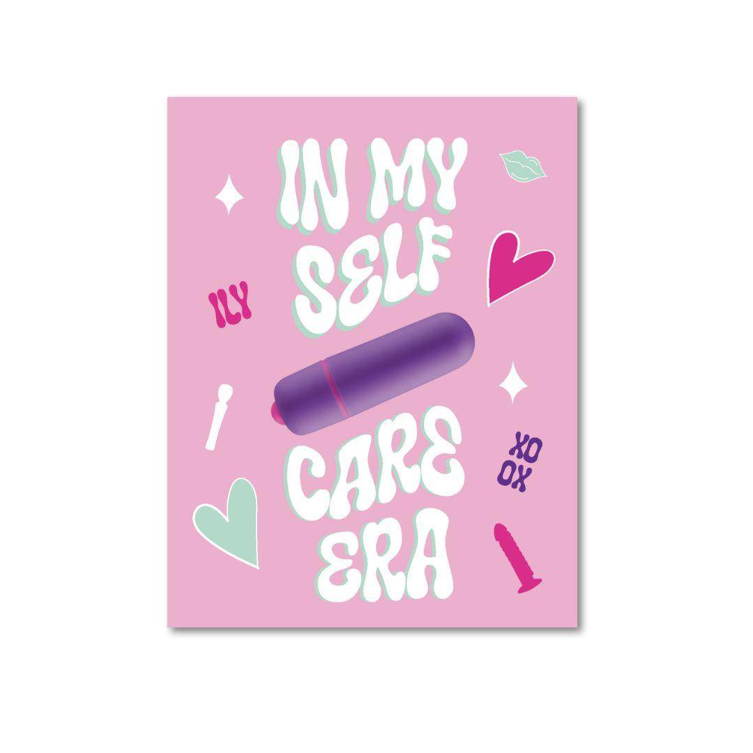 A playful greeting card with a pink background featuring the phrase 'In My Self Care Era' in bold, stylized white and mint green letters. A purple vibrator is prominently displayed in the center, signifying the card's humorous and self-love theme. Additional decorations include small hearts, a lipstick kiss mark, and the playful sign-off 'XO.'