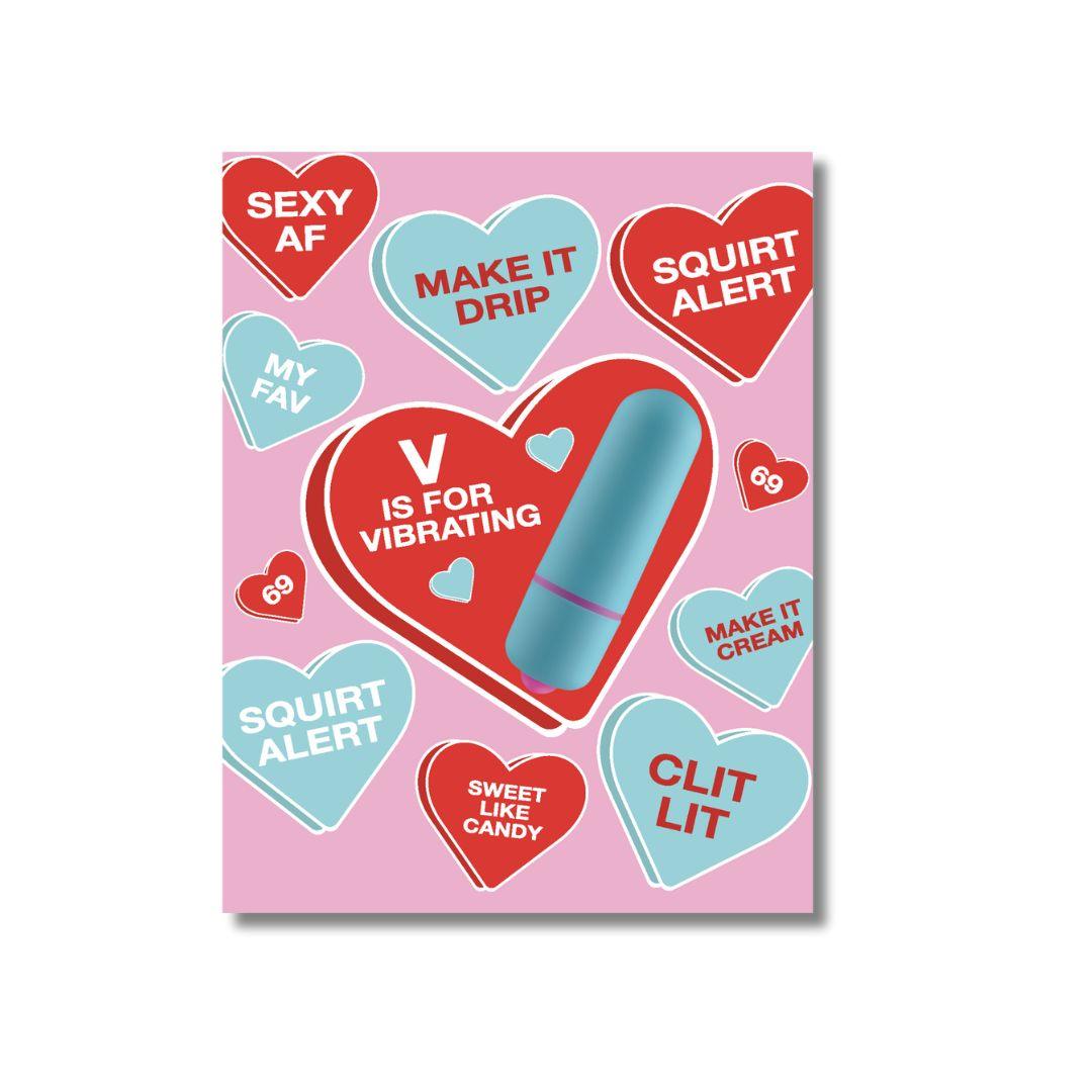 A playful and suggestive greeting card with a pink background, decorated with various candy hearts in shades of blue and red, each featuring flirty and provocative phrases. A large heart in the center displays a blue vibrator with the text 'V is for Vibrating'.