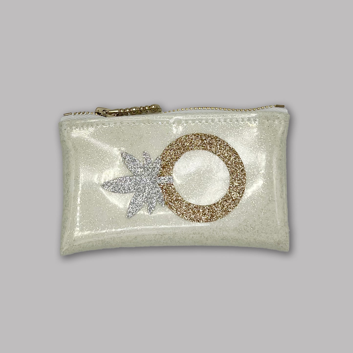 A chic white glitter vinyl keychain clutch featuring a gold glitter engagement ring and silver cannabis leaf design. A stylish and compact stash bag designed by Kush Kards in collaboration with Julie Mollo, perfect for holding small essentials like rolling papers, lighters, and cash